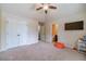 This bedroom features carpet, a ceiling fan, and a television for comfort and entertainment at 882 Nestling Dr, Lawrenceville, GA 30045