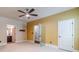Bedroom featuring a ceiling fan, doorway to bathroom, and doorway to closet at 882 Nestling Dr, Lawrenceville, GA 30045