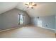 Spacious upstairs bedroom with plush carpet, a ceiling fan, and natural light at 882 Nestling Dr, Lawrenceville, GA 30045
