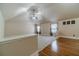 Upstairs bonus room with vaulted ceiling, hardwood and carpet flooring at 882 Nestling Dr, Lawrenceville, GA 30045