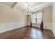 Elegant dining room with hardwood floors, coffered ceiling, and a chandelier at 882 Nestling Dr, Lawrenceville, GA 30045