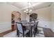 Elegant dining room with coffered ceilings, chandelier, and hardwood floors at 882 Nestling Dr, Lawrenceville, GA 30045