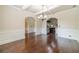 Open dining area with hardwood floors, seamlessly connecting to the kitchen through arched openings at 882 Nestling Dr, Lawrenceville, GA 30045