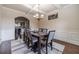 Elegant dining room with coffered ceilings, chandelier, and hardwood floors at 882 Nestling Dr, Lawrenceville, GA 30045