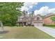 Traditional two-story brick home with well-manicured lawn and lush landscaping at 882 Nestling Dr, Lawrenceville, GA 30045