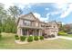 Well-manicured front lawn and garden with a view of a two story brick home at 882 Nestling Dr, Lawrenceville, GA 30045