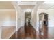 Spacious foyer with hardwood floors, decorative trim, and arched openings to adjoining rooms at 882 Nestling Dr, Lawrenceville, GA 30045