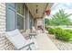 Relaxing front porch with chairs, side tables, and a hanging flower basket at 882 Nestling Dr, Lawrenceville, GA 30045