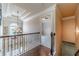 Upstairs hallway with hardwood floors, decorative chandelier and architectural ceiling at 882 Nestling Dr, Lawrenceville, GA 30045