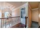 Upstairs hallway with hardwood floors and chandelier at 882 Nestling Dr, Lawrenceville, GA 30045