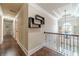 Upstairs hallway with hardwood floors, decorative chandelier and architectural ceiling at 882 Nestling Dr, Lawrenceville, GA 30045