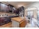 Modern kitchen features dark cabinets, stainless steel appliances, and a central island with breakfast bar at 882 Nestling Dr, Lawrenceville, GA 30045