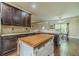 Modern kitchen featuring dark wood cabinets, granite countertops, and a functional kitchen island at 882 Nestling Dr, Lawrenceville, GA 30045