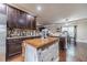 Charming kitchen with dark wood cabinets, granite countertops, and a functional center island at 882 Nestling Dr, Lawrenceville, GA 30045
