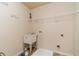 Functional laundry room featuring a utility sink, practical shelving, and tile flooring at 882 Nestling Dr, Lawrenceville, GA 30045