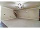 Spacious living room featuring plush carpet, stairs, ceiling fan, and neutral wall color at 882 Nestling Dr, Lawrenceville, GA 30045