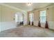 Bright living room featuring carpet, paneled walls, and natural light from two large windows at 882 Nestling Dr, Lawrenceville, GA 30045