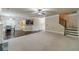 Open living area with carpet, hardwood floors, and view to the kitchen and staircase at 882 Nestling Dr, Lawrenceville, GA 30045