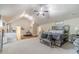 Large, carpeted main bedroom with vaulted ceilings, a ceiling fan, and wood floors in the bonus area at 882 Nestling Dr, Lawrenceville, GA 30045