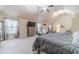 Cozy main bedroom boasts soft carpet, a ceiling fan, and lots of natural light through the windows at 882 Nestling Dr, Lawrenceville, GA 30045