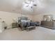 Bright main bedroom featuring cozy carpet, a ceiling fan, and ample natural light at 882 Nestling Dr, Lawrenceville, GA 30045