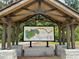 Covered park map kiosk with map of Tribble Mill Park in a wooded area at 882 Nestling Dr, Lawrenceville, GA 30045