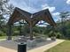 Covered picnic shelter in wooded area with multiple picnic tables and trash can at 882 Nestling Dr, Lawrenceville, GA 30045
