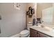 Cozy powder room featuring modern fixtures and decor with a single sink vanity at 882 Nestling Dr, Lawrenceville, GA 30045