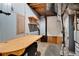 Unfinished basement with exposed ductwork, wood shelving, and a work table, perfect for storage and projects at 1055 Heather Ct, Lawrenceville, GA 30043