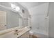 Well-lit bathroom featuring a vanity with a wide mirror, a toilet, and a tiled shower-tub combo at 1055 Heather Ct, Lawrenceville, GA 30043