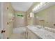 Bright bathroom features a tub and shower, vanity with a large mirror, and a window at 1055 Heather Ct, Lawrenceville, GA 30043
