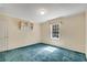 Bedroom with blue carpet, neutral walls, window, and door to closet at 1055 Heather Ct, Lawrenceville, GA 30043