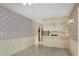 Dining room with breakfast bar, patterned wallpaper, and adjacent stairwell at 1055 Heather Ct, Lawrenceville, GA 30043