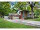 View of the exterior with a long driveway to the house and detached garage at 1055 Heather Ct, Lawrenceville, GA 30043