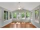 Bright sunroom featuring hardwood floors, lots of windows, and a ceiling fan at 1055 Heather Ct, Lawrenceville, GA 30043