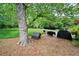 Beautiful backyard offering plenty of space with large mature trees, doghouse, and outdoor grills at 1470 Rhododendron Nw Dr, Acworth, GA 30102