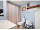 Light-blue bathroom featuring a sink, toilet, shower curtain and shelving at 1470 Rhododendron Nw Dr, Acworth, GA 30102