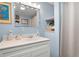 Light-blue bathroom featuring a large mirror with bright lights and a shower at 1470 Rhododendron Nw Dr, Acworth, GA 30102