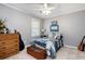 Charming bedroom featuring a ceiling fan, neutral walls, and a comfortable bed with a decorative quilt at 1470 Rhododendron Nw Dr, Acworth, GA 30102