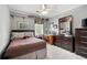 Comfortable bedroom featuring neutral walls, ceiling fan and traditional-style dark wood furniture at 1470 Rhododendron Nw Dr, Acworth, GA 30102