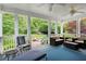 Relaxing covered porch with ceiling fan and outdoor furniture overlooking the lush green backyard at 1470 Rhododendron Nw Dr, Acworth, GA 30102