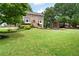 Spacious front lawn with a beautiful brick home, mature trees, and colorful landscaping at 1470 Rhododendron Nw Dr, Acworth, GA 30102