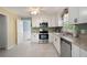 Well-lit kitchen with stainless steel appliances, granite countertops, white cabinetry, and tile floors at 1470 Rhododendron Nw Dr, Acworth, GA 30102