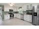 Spacious kitchen features white cabinets, stainless steel appliances, granite counters and tile flooring at 1470 Rhododendron Nw Dr, Acworth, GA 30102