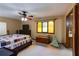 Cozy bedroom with a comfortable bed, ceiling fan, and a brightly colored window at 2425 Maclaren Cir, Dunwoody, GA 30360