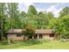 Charming brick home with lush greenery and well-maintained front yard landscaping at 2425 Maclaren Cir, Dunwoody, GA 30360
