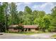 Charming brick home with well-maintained landscaping and mature trees at 2425 Maclaren Cir, Dunwoody, GA 30360