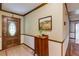 Classic foyer with wooden door, tiled floor, cabinet and elegant trim details at 2425 Maclaren Cir, Dunwoody, GA 30360