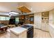 Open kitchen view with tiled countertops, island cooktop, and cozy access to living room at 2425 Maclaren Cir, Dunwoody, GA 30360