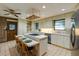 Open kitchen with tiled countertops, modern appliances, and a spacious island with seating at 2425 Maclaren Cir, Dunwoody, GA 30360